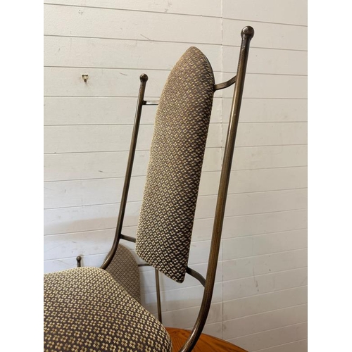 22 - A wrought iron circular dining table and chairs, the table with a wooden top and the chairs upholste... 