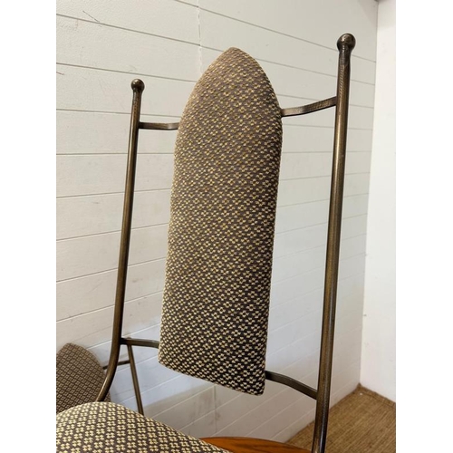 22 - A wrought iron circular dining table and chairs, the table with a wooden top and the chairs upholste... 