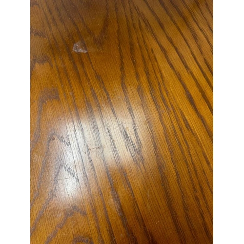 22 - A wrought iron circular dining table and chairs, the table with a wooden top and the chairs upholste... 