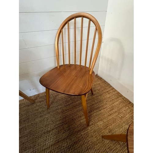 25 - A blonde Ercol Windsor extendable dining table with six matching chairs