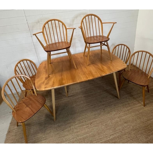 25 - A blonde Ercol Windsor extendable dining table with six matching chairs