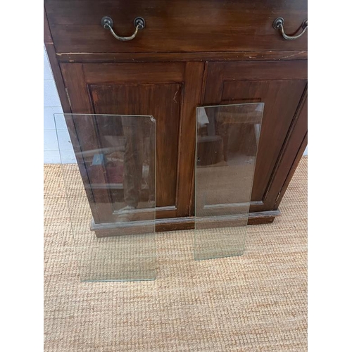 26 - A glazed display unit upon a cabinet base with panelled doors (H174cm W81cm D50cm)