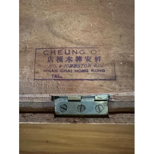 29 - A Chinese ornately carved camphor wood chest with brass fittings and featuring a desert scape scene ... 