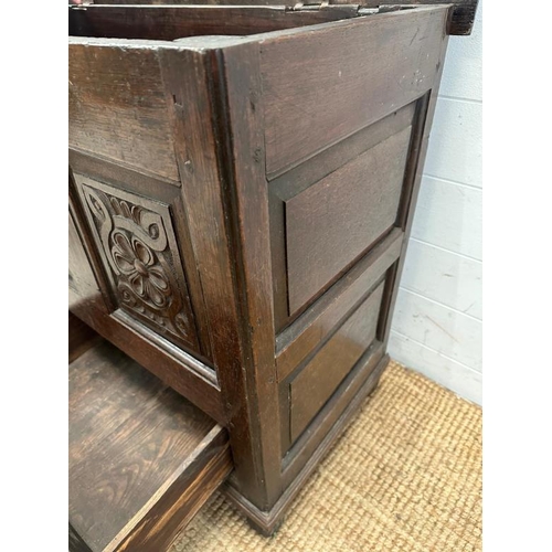 3 - A dark oak mule chest with carved panels and drawers, hinged lid opening to storage with two drawers... 