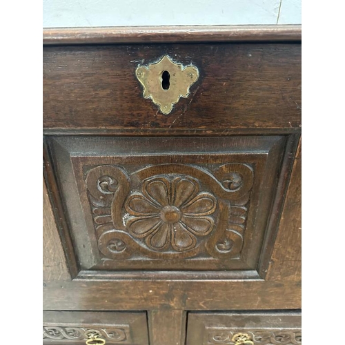 3 - A dark oak mule chest with carved panels and drawers, hinged lid opening to storage with two drawers... 