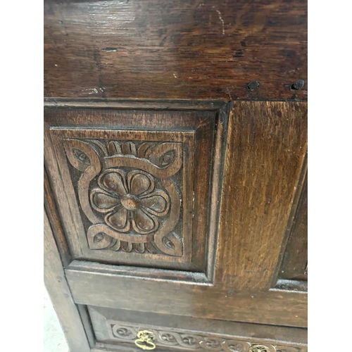 3 - A dark oak mule chest with carved panels and drawers, hinged lid opening to storage with two drawers... 