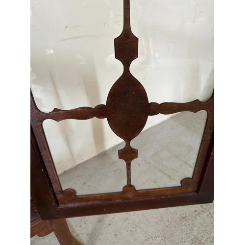 34 - A mahogany glazed corner display cabinet on tripod legs with a scrolling inlay (H110cm W59cm D30cm)