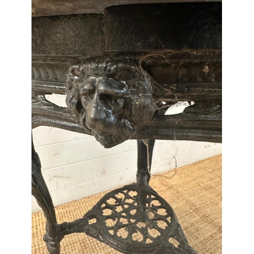 4 - A vintage black painted circular cast iron pub table with a wooden top (H75cm Dia68cm)