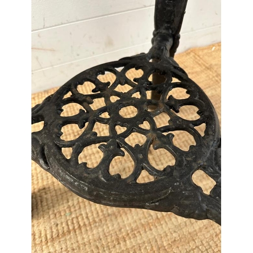 4 - A vintage black painted circular cast iron pub table with a wooden top (H75cm Dia68cm)