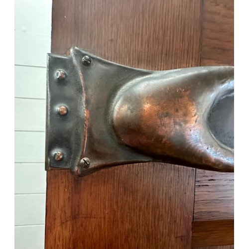 5 - An Arts and Crafts style oak linen press, the cupboard opening to four drawers over two short and tw... 