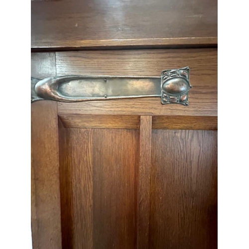 5 - An Arts and Crafts style oak linen press, the cupboard opening to four drawers over two short and tw... 