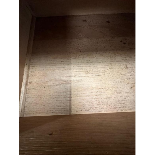 5 - An Arts and Crafts style oak linen press, the cupboard opening to four drawers over two short and tw... 