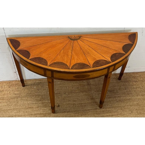 55 - A Demi Lune side table with veneered top on tapering legs (H73cm W130cm D47cm)