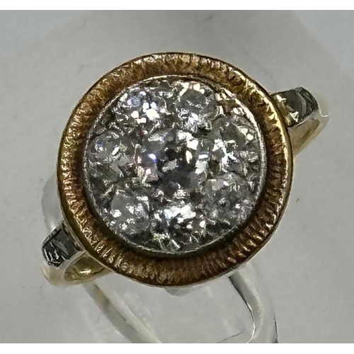 580 - A diamond ring with central stone surrounded by seven others with diamond shoulders Size L