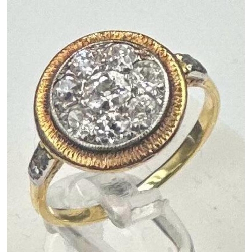 580 - A diamond ring with central stone surrounded by seven others with diamond shoulders Size L