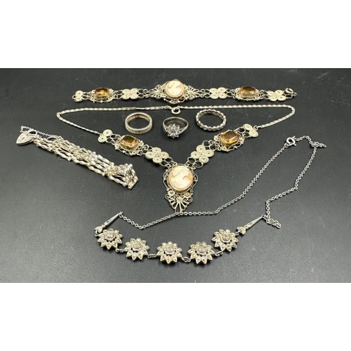 618 - A small selection of costume jewellery to include a 9ct and silver ring.