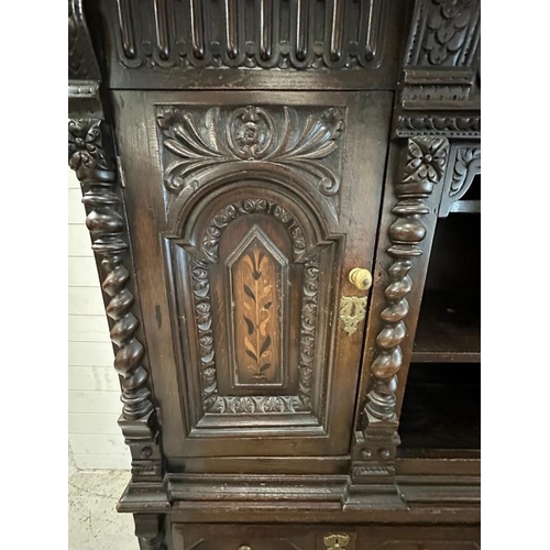 8 - A heavily carved court cabinet on stand