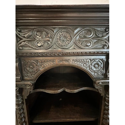 8 - A heavily carved court cabinet on stand