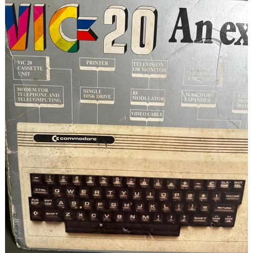 809 - A boxed Commodore Vig 20 colour computer and a pair of Atari joystick controllers