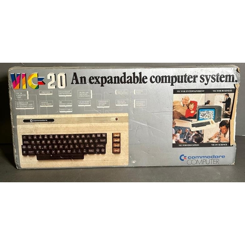 809 - A boxed Commodore Vig 20 colour computer and a pair of Atari joystick controllers