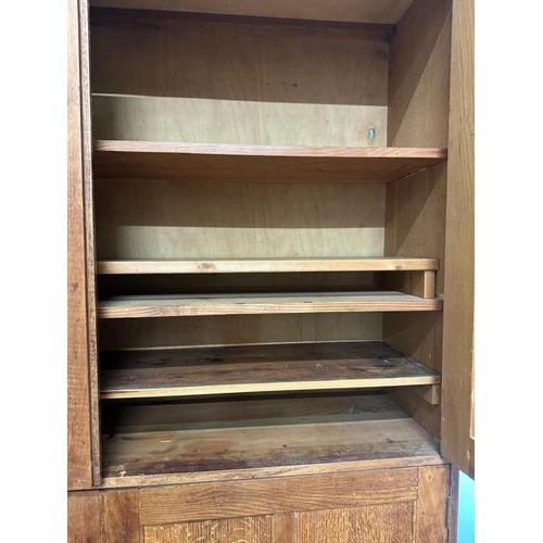 9 - A large arts and crafts pine kitchen storage cupboard, two over two door cupboards with a total of f... 