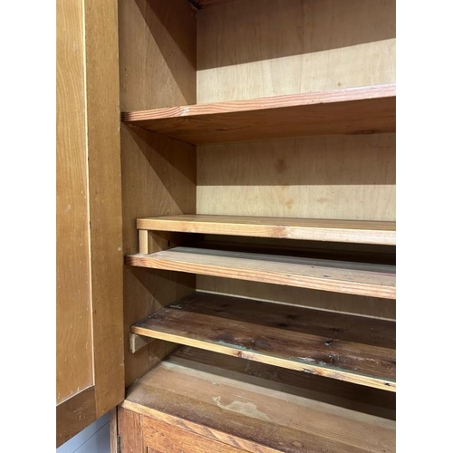 9 - A large arts and crafts pine kitchen storage cupboard, two over two door cupboards with a total of f... 