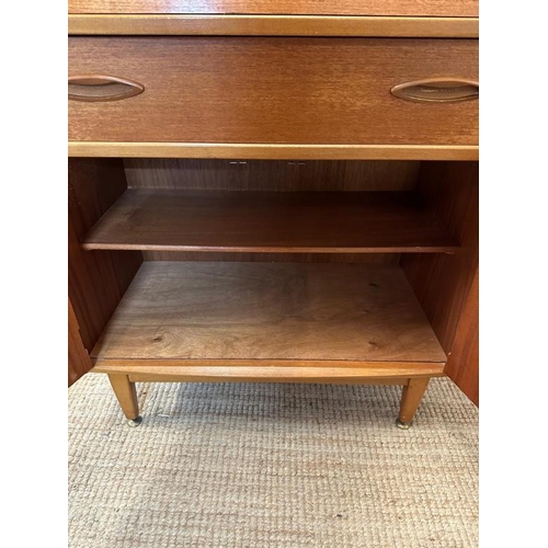 14 - A teak Mid Century bureau, single long drawer with cupboard under. The fall opening to two small dra... 