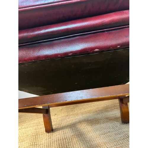 121 - A red leather chesterfield wing back chair