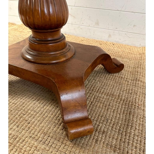 129 - An Art Deco style oval centre table on turned central pedestal and sprayed feet (H80cm W120cm D87cm)