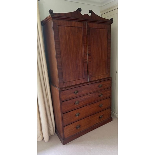 136 - A Regency mahogany linen cupboard with panelled doors opening to fixed shelves sat upon a base compr... 