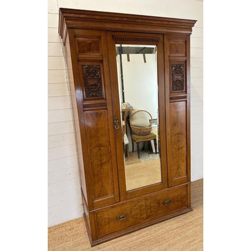 111 - A Victorian oak wardrobe with walnut inlay, mirrored door and drawer under by Blyh and Sons of Londo... 