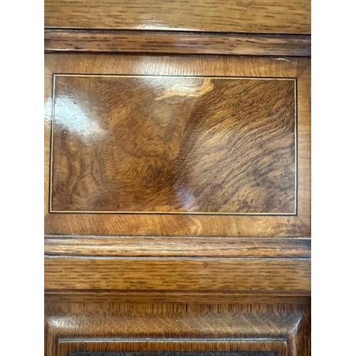 111 - A Victorian oak wardrobe with walnut inlay, mirrored door and drawer under by Blyh and Sons of Londo... 