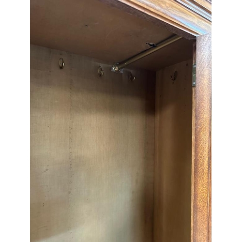 111 - A Victorian oak wardrobe with walnut inlay, mirrored door and drawer under by Blyh and Sons of Londo... 