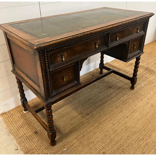 116 - 1920's Jacobean style kneehole desk with leather top over an arrangement of four frieze drawers (109... 