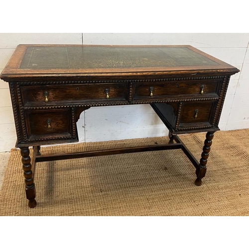 116 - 1920's Jacobean style kneehole desk with leather top over an arrangement of four frieze drawers (109... 