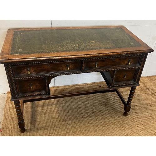 116 - 1920's Jacobean style kneehole desk with leather top over an arrangement of four frieze drawers (109... 