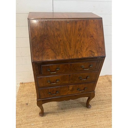 118 - A reproduction bureau on cabriole legs (H107cm W61cm D42cm)