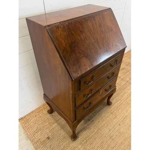 118 - A reproduction bureau on cabriole legs (H107cm W61cm D42cm)