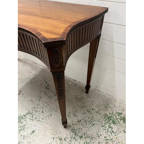 88 - A mahogany serpentine serving table/console on tapering legs (H84cm W137cm D54cm)