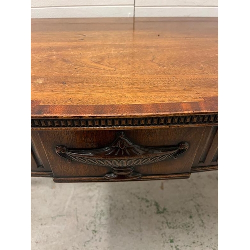 88 - A mahogany serpentine serving table/console on tapering legs (H84cm W137cm D54cm)