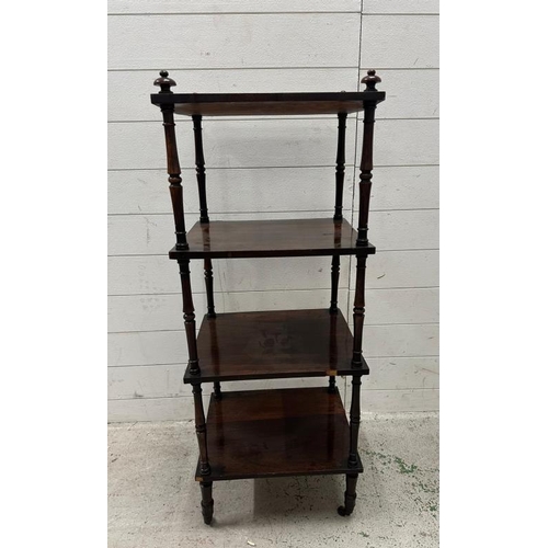98 - A mahogany three tier whatnot, turned supports, castors and finials to top (H125cm W40cm D34cm)