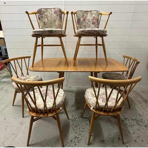 182 - A mid century drop leaf dining table with four spindle back chairs and two carvers