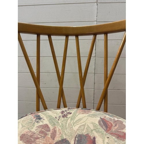 182 - A mid century drop leaf dining table with four spindle back chairs and two carvers