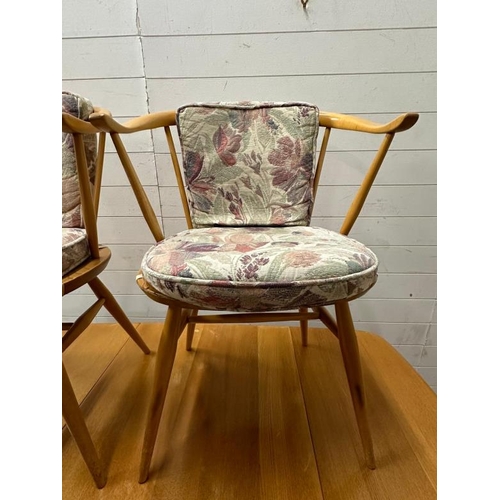 182 - A mid century drop leaf dining table with four spindle back chairs and two carvers