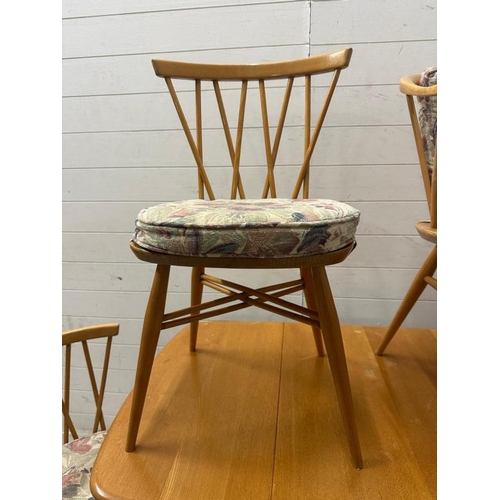 182 - A mid century drop leaf dining table with four spindle back chairs and two carvers