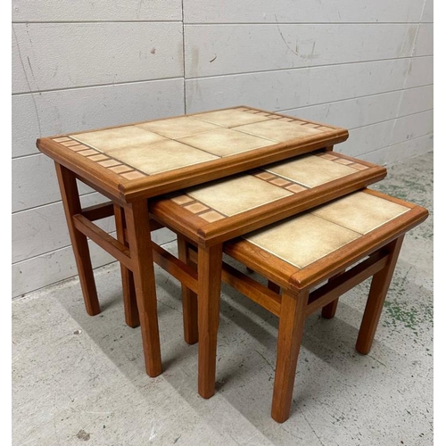 193 - A nest of three Mid Century tile topped tables (Largest H43cm W56cm D34cm)