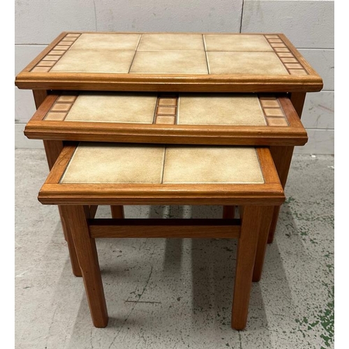 193 - A nest of three Mid Century tile topped tables (Largest H43cm W56cm D34cm)