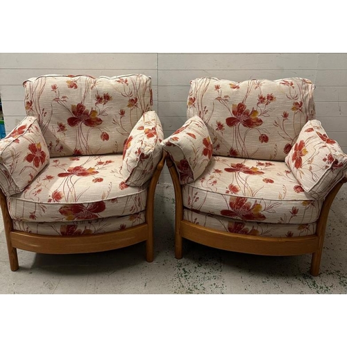 194 - A pair of light Ercol arm chairs upholstered in a floral linen