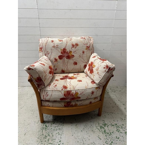 194 - A pair of light Ercol arm chairs upholstered in a floral linen