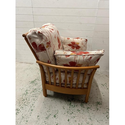 194 - A pair of light Ercol arm chairs upholstered in a floral linen